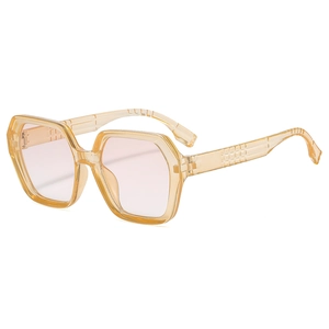 Stylish oversized polygonal sunglasses with champagne frames and light pink lenses
