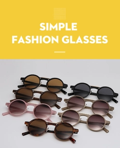 Various stylish retro round sunglasses in black, tortoiseshell and pink frames on gray background