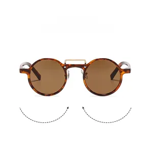 Detail of round tortoiseshell sunglasses with brown lenses and golden metal double bridge