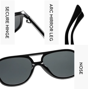 Detail view of reinforced hinges, curved legs and nose bridge on black pilot sunglasses