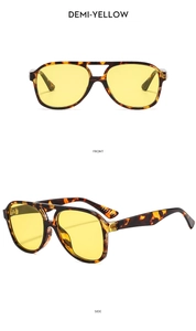 Detail of demi-yellow navigator sunglasses with tortoiseshell frames and double bridge