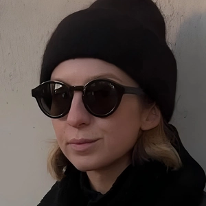 Fashionable black knit beanie hat and round sunglasses for a stylish minimalist street look