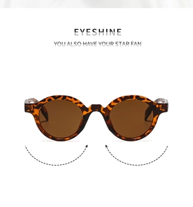 Detail of vintage round leopard print sunglasses with dark brown lenses and metal logo