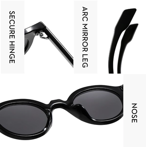 Close-up of secure metal hinge and ergonomic temples on black oval sunglasses