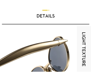 Detail view of gold oval metal sunglasses frame with light texture and gray lenses