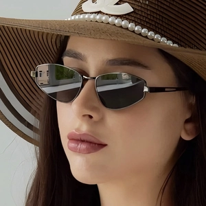 Detail of silver cat-eye sunglasses with metallic frames and mirrored gray lenses