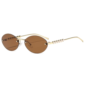 Lunettes de soleil ovales sans monture pour femme avec branches dorées et perles blanches