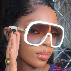 Oversized white frame sunglasses with gradient lenses and gold metal temples on model