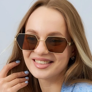 Chic hexagonal gold metal sunglasses with brown polarized lenses worn by a model