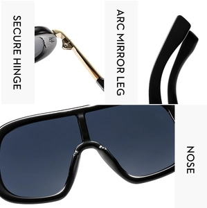 Detail view of large frame sunglasses showing metal hinges and curved temples