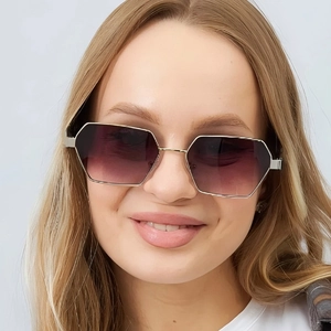 Close-up of elegant gold polygon sunglasses with purple gradient lenses on a female model
