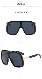 Front and 45-degree side views of black oversized sunglasses with gold metal accents