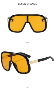 Detail view of large frame one-piece sunglasses with orange lenses and gold metal accents