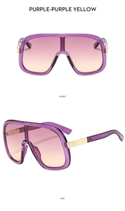 Detail of oversized purple fashion sunglasses with gradient lenses and gold metal hinges