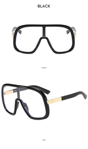 Detail view of large frame oversized sunglasses with golden metal hinges in black