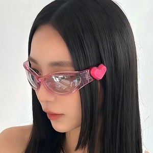 Pink oval sunglasses with heart decor and transparent frames in a Y2K trendy style