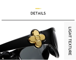 Detailed macro of black glossy temples with gold four-petal flower metal ornament