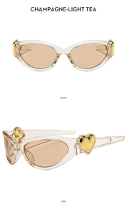 Detail of champagne oval sunglasses showing gold heart accent and side hinge hardware