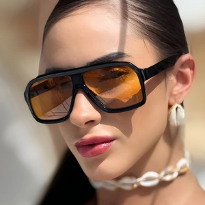 Retro oversized square aviator sunglasses with black frames and amber orange lenses
