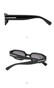 Détail de lunettes de soleil noires avec incrustations métalliques et charnières