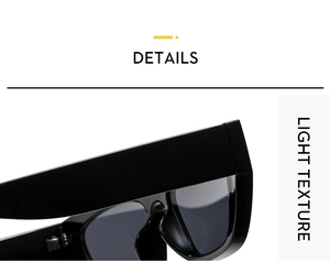Close-up of black oversized sunglasses showing the thick frame and light texture hinge