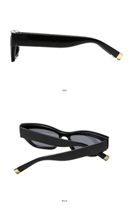 Detail view showing side and back of black thick-frame sunglasses with gold metal trim