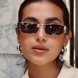 Y2K square metal sunglasses with dark lenses and silver earrings shown on model