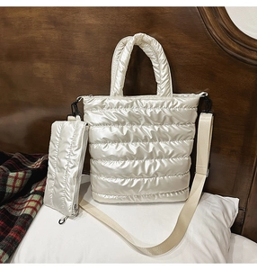 Detailed view of champagne quilted puffer tote bag with matching zipper pouch