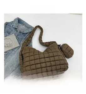 Detailed view of dark brown quilted puffer tote bag with a small matching coin purse