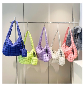 Detailed row of quilted cloud tote bags in five colors with matching mini pouches