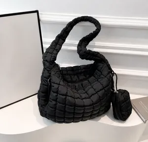 Macro shot of black quilted cloud tote bag texture with matching mini round coin purse