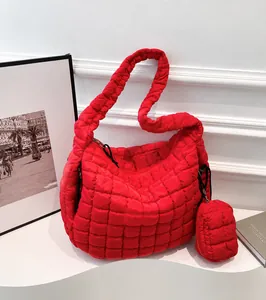 Detail of red quilted tote bag with matching mini pouch and soft padded shoulder strap