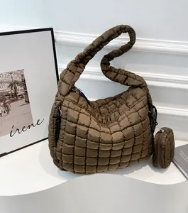 Detailed view of the brown quilted puffy tote bag texture with a matching coin purse