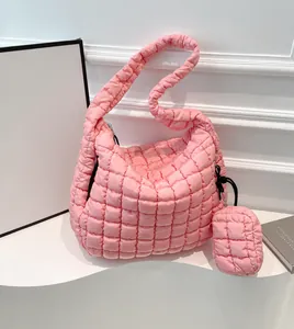 Pink quilted cloud tote bag with matching small coin purse on minimalist display