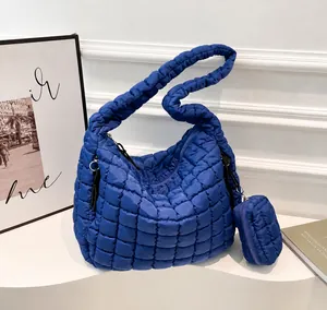 Close-up of blue quilted cloud tote bag with matching round hanging coin purse