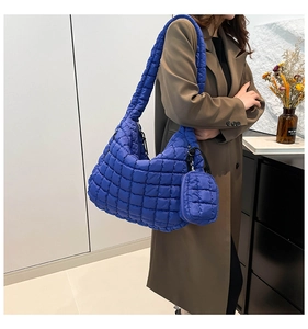Close-up of Klein blue quilted puffer bag with matching detachable mini coin purse