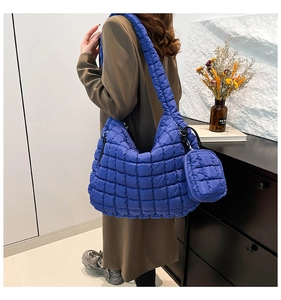 Quilted royal blue puffy cloud bag with shoulder strap and matching round coin purse