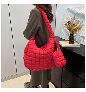 Detail of red quilted puffer cloud tote bag with matching mini pouch and nylon texture