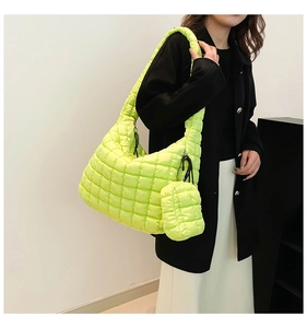 Detailed view of neon green quilted down tote bag with matching mini zip pouch accessory