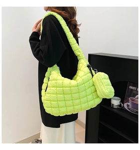 Detail of neon green quilted cloud tote bag with matching mini coin purse and shoulder strap