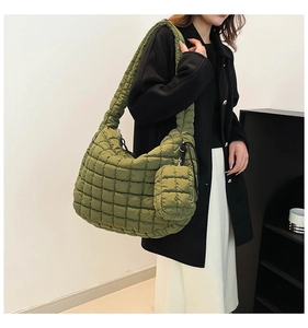 Detailed close-up of army green quilted puffer bag with matching zipper coin pouch accessory