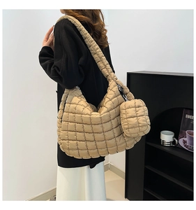 Detail of quilted puffy tote bag in beige nylon featuring a matching detachable mini pouch