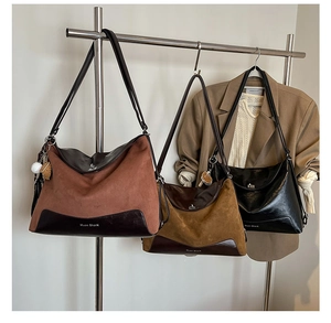 Detail of multi-color tote bags with suede patchwork and shoulder strap display