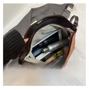 Interior view of brown leather tote bag showing large capacity for tablet and cosmetics