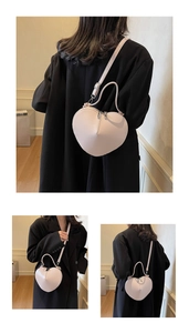 Multiple views of a heart-shaped crossbody bag worn with a black blazer for styling