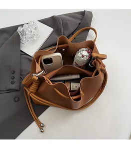 Interior view of brown leather bucket bag showing large capacity and zipper compartment