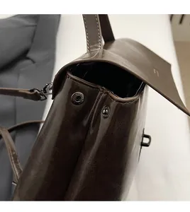 Detailansicht der dunkelbraunen Vintage-Ledertasche mit Metallschnalle und Nähten