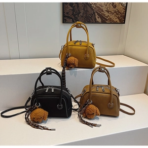 Litchi pattern leather bowling bags in yellow, black, and brown with cute dog charms