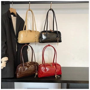 Macro detail of glossy oil wax leather bags in beige, black, brown and red colors
