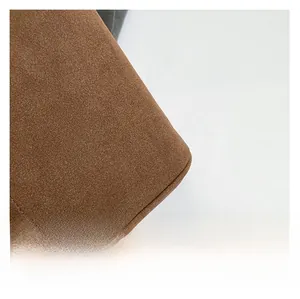 Detailed macro view of premium brown suede leather texture with neat stitching craftsmanship